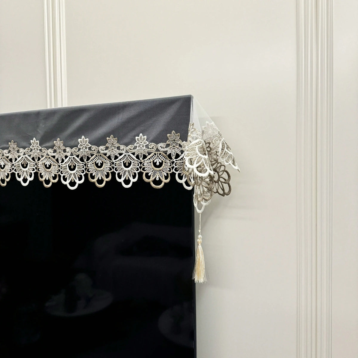 Black table runner featuring intricate silver embroidered mesh lace with dangling pendants