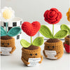 Handmade crochet emotional support plant dolls in various colors like red and green