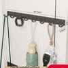 A set of eight grey clothes hooks mounted on a white wall, showing the hooks and mounting hardware.