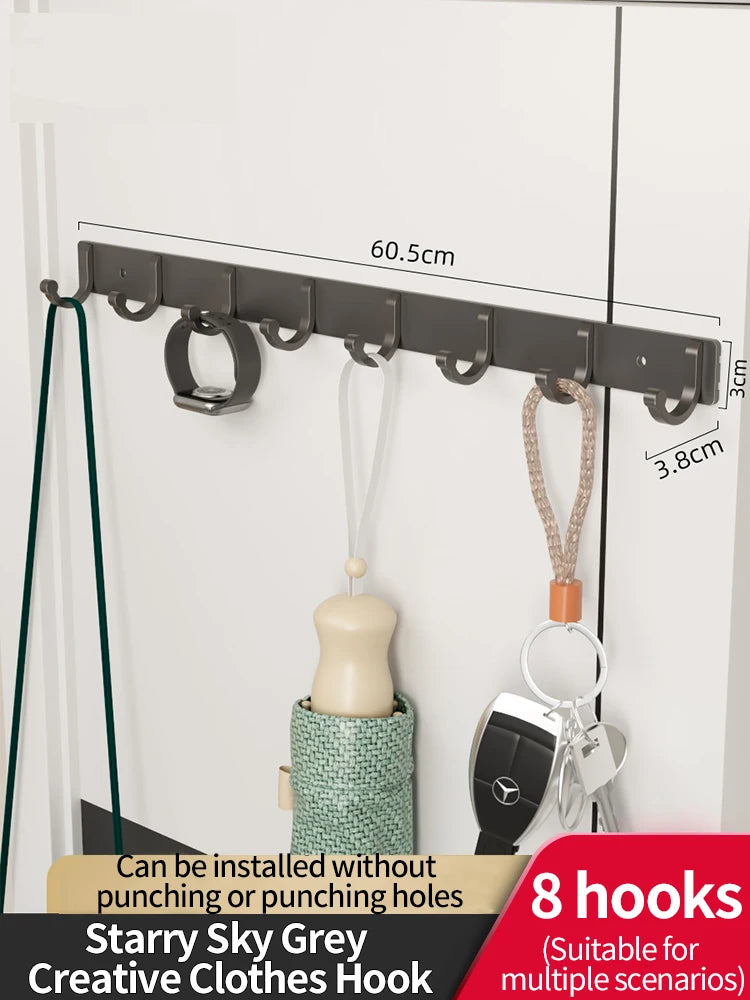 A set of eight grey clothes hooks mounted on a white wall, showing the hooks and mounting hardware.
