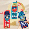 A hand holds a red kids learning toy smartphone with a blue case and a light green version.