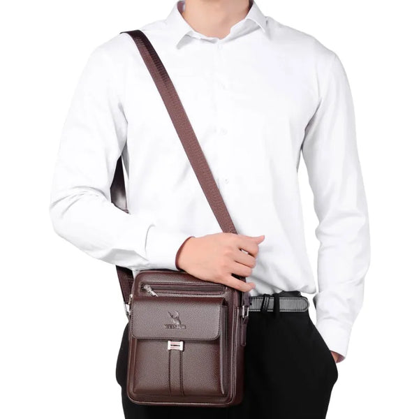 A brown vintage waterproof crossbody messenger bag worn by a man in a white shirt and black pants.