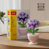 A box of K340 flower pot building blocks set containing 119 pieces of purple roses and other flowers.