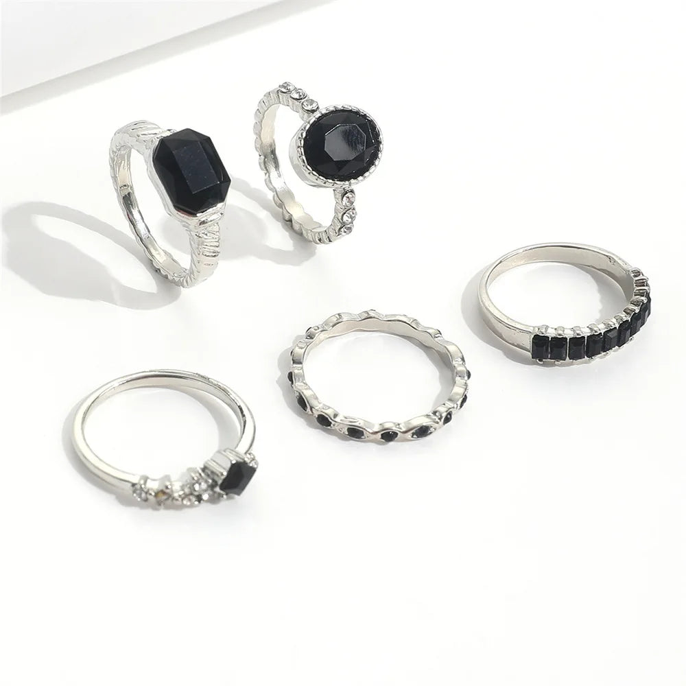 A set of vintage black crystal rings featuring various designs and stone cuts.