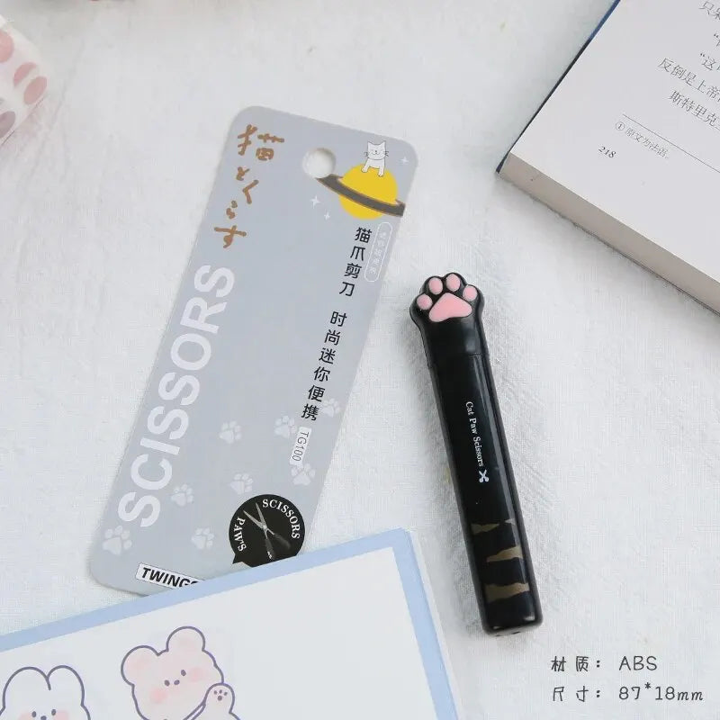 A pair of black portable scissors with a cat paw design is shown next to product information and a white background.