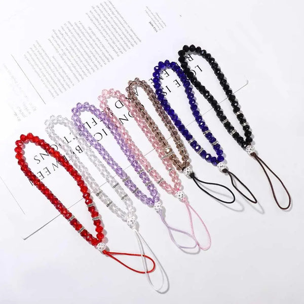 A collection of crystal bead phone lanyards featuring various colors including purple, pink, and black.