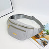 A light gray nylon waist pack with a zipper and gold accent is displayed on a white surface.