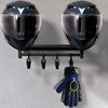 A pair of black motorcycle helmets are displayed on a wooden wall mount shelf.