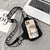 A black canvas chest bag with a strap featuring text and a phone inside, resting on a gray fabric next to a laptop.