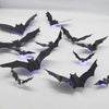 Black bat silhouette wall décor with LED glow lights displayed on a white surface.