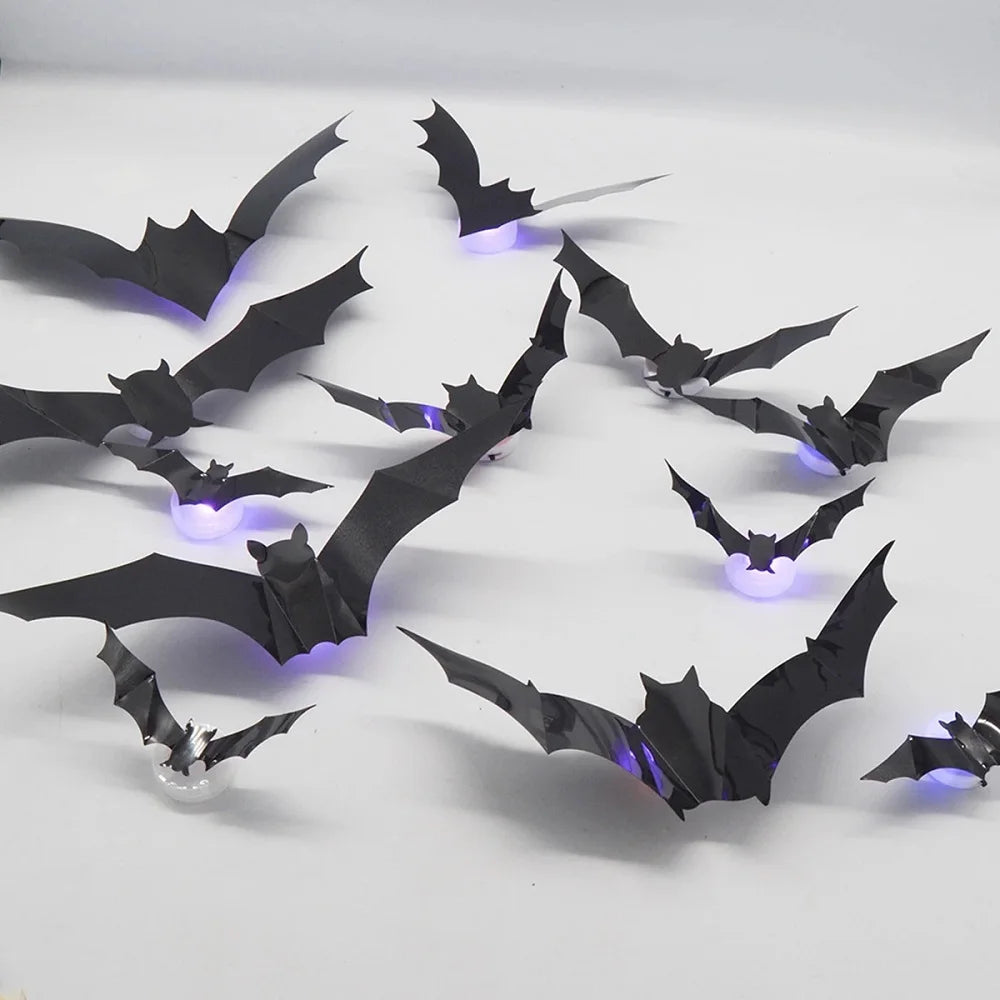 Black bat silhouette wall décor with LED glow lights displayed on a white surface.