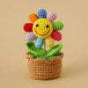 Handcrafted crochet sunflower with colorful petals growing in a brown pot