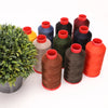 A collection of spools of heavy-duty nylon bonded thread in various colors including red, orange, green, blue, and black.