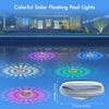 Colorful solar floating pool lights illuminating water with various light patterns.
