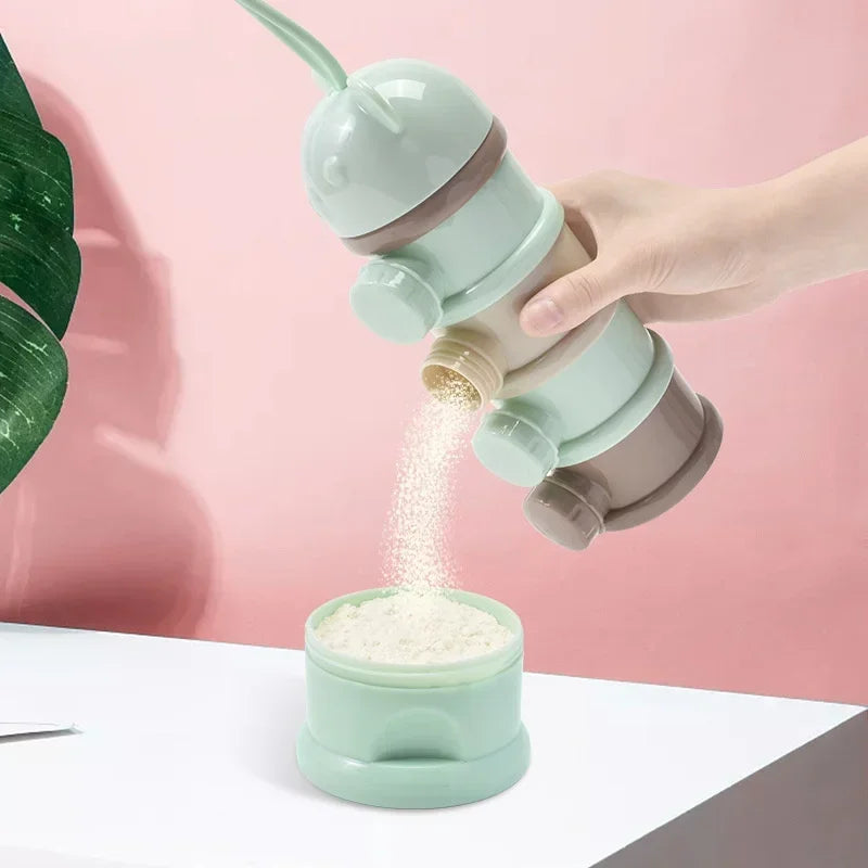 A hand is pouring a light green baby food storage container filled with white food into another container.