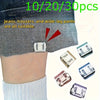A set of invisible hem shortening clips in various sizes and colors shown against denim fabric.