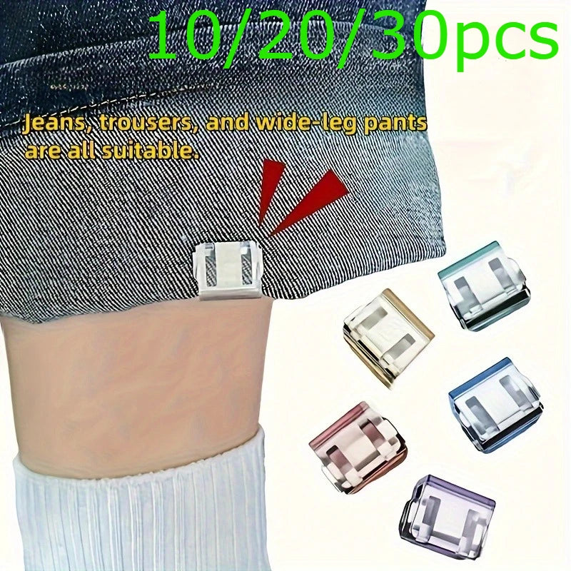 A set of invisible hem shortening clips in various sizes and colors shown against denim fabric.