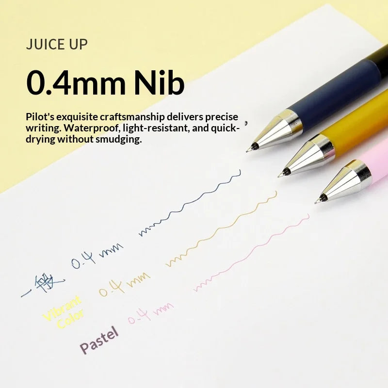 Ein Set von Pilot Juice Up 0,4mm Nibs in blau, gelb und pink, die auf weißem Papier schreiben.