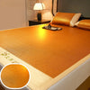 A close-up view of an orange cooling mat with a textured surface and a white border, placed on a bed.