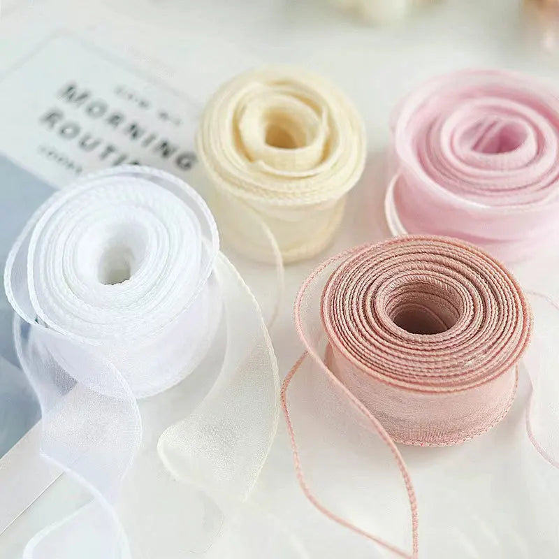 Rolls of wavy edge organza ribbon in white and pink colors for DIY crafts and gift wrapping