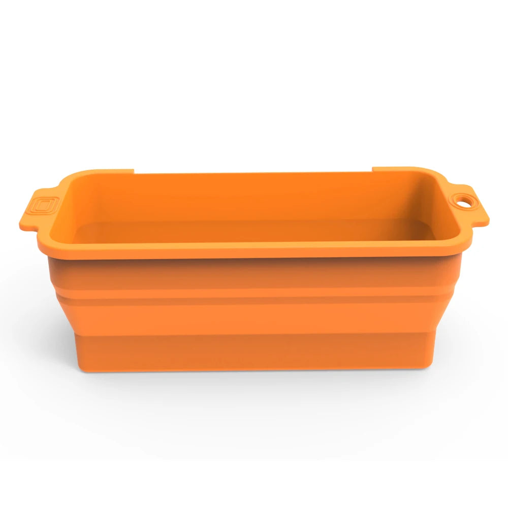 An orange reusable silicone grease liner for a griddle pan.