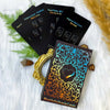 A black oracle card deck featuring spreads like Future Love, You/Them, and Push & Pull Love, resting on white fur.