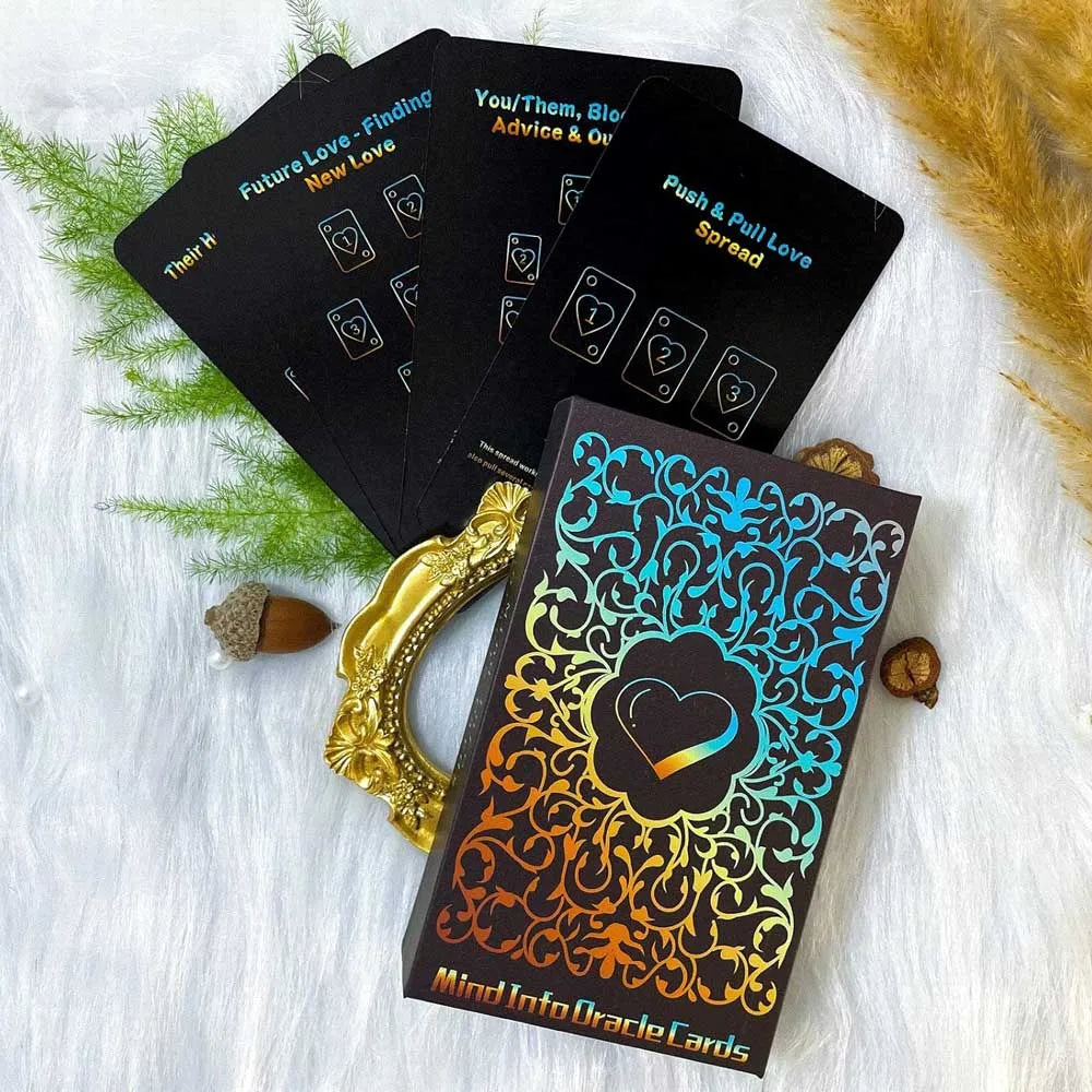 A black oracle card deck featuring spreads like Future Love, You/Them, and Push & Pull Love, resting on white fur.