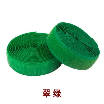 Roll of green sew-on hook and loop tape fastener strip