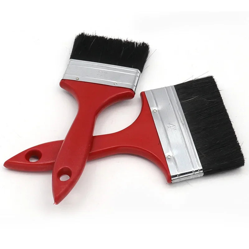 A red paint brush with a silver ferrule and black bristles is shown on a white background.