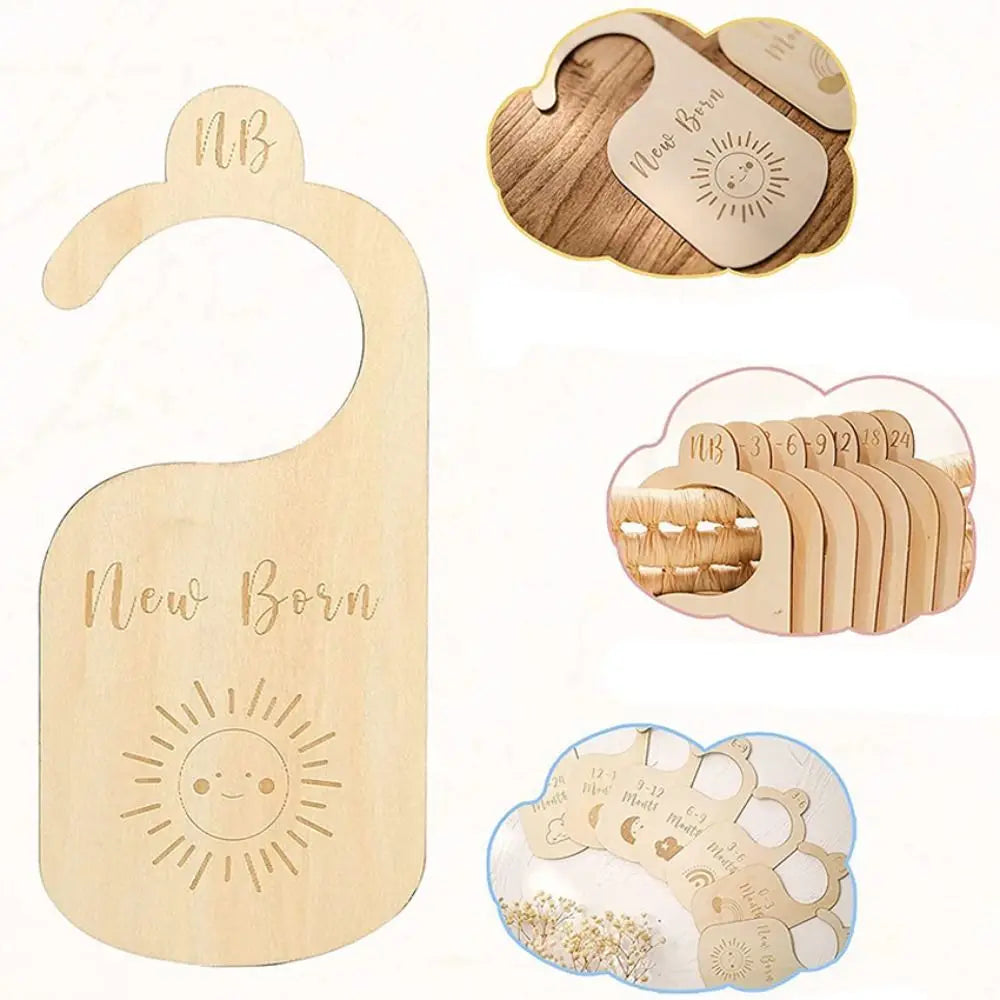 Wooden baby closet dividers with natural wood labels and cartoon designs for organizing baby clothes.