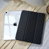 A black slim protective iPad case with built-in pencil holder resting on a light yellow fabric.