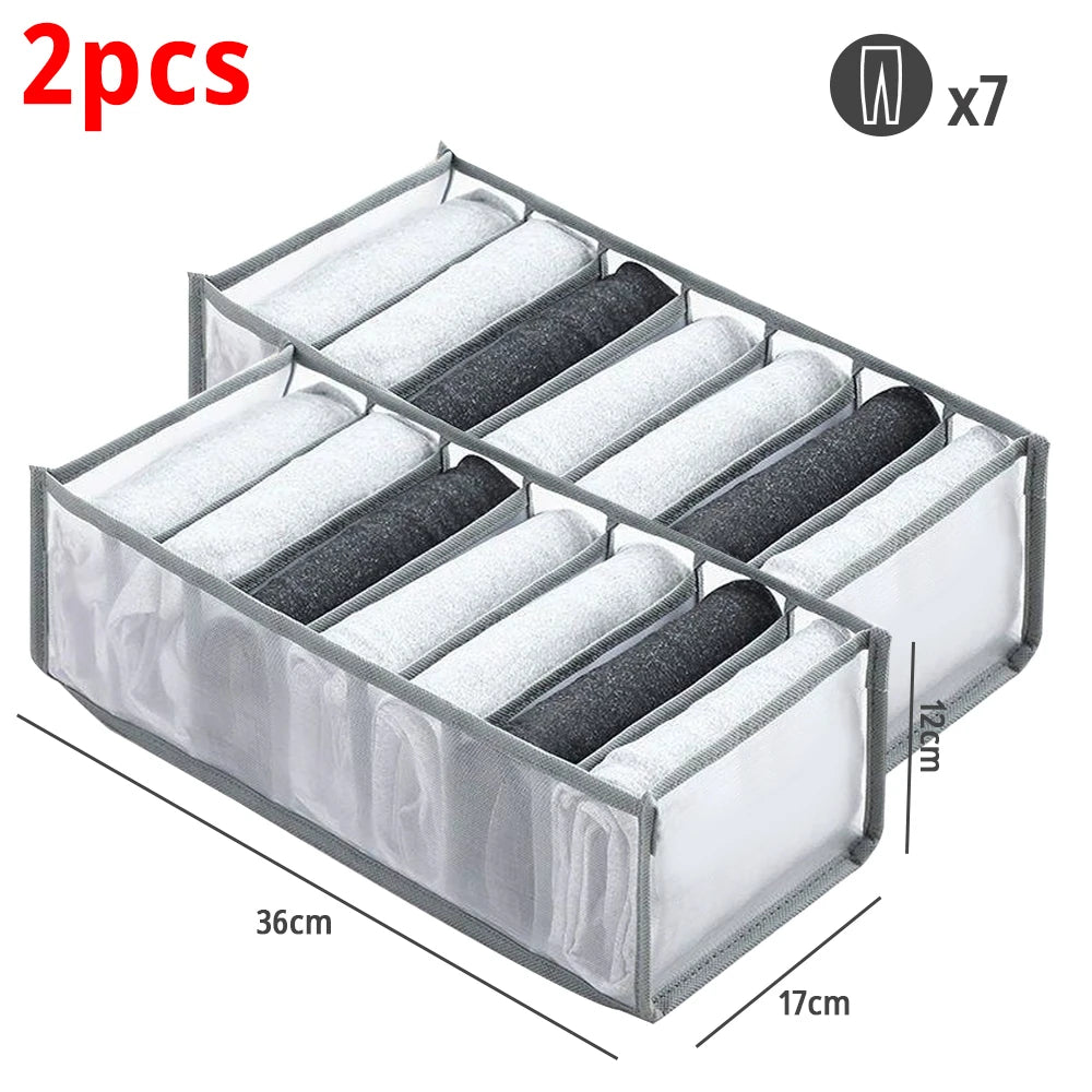 A rectangular fabric closet organizer with seven folded gray and white fabric items inside.