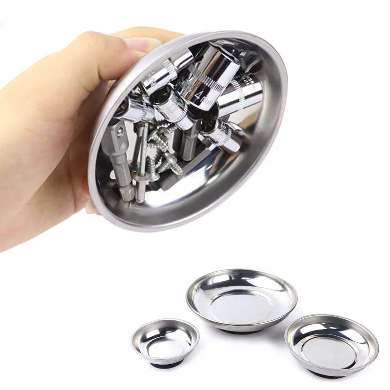 A hand holds a silver magnetic parts tray with various hardware components inside.