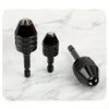 Three black quick-change hex shank drill chucks with round handles displayed on a white marble surface.
