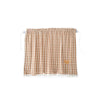 A brown and white checkered sun shade curtain featuring a small bear patch.