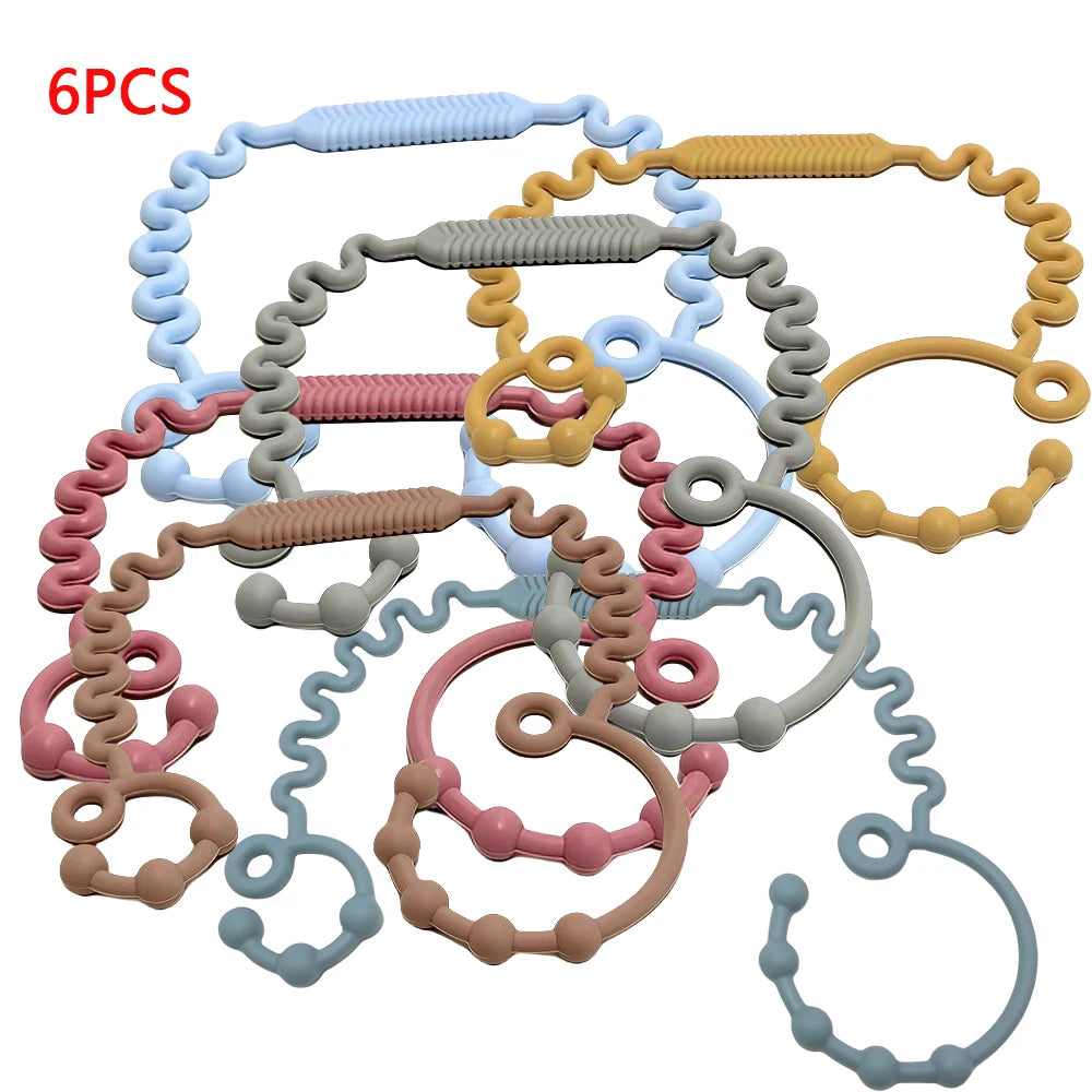 Six silicone anti-drop pacifier clips and teethers in various colors like blue, pink, yellow, and gray.