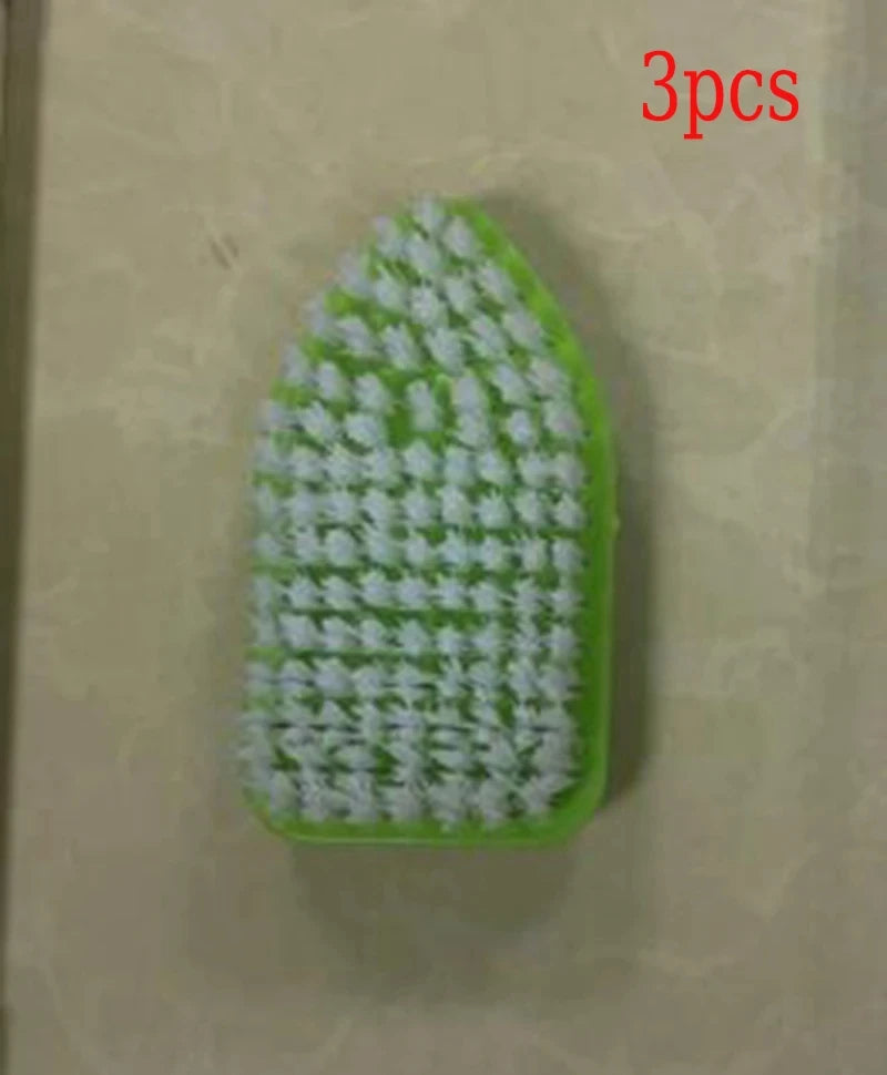 A green triangular floor brush with white bristles is shown against a light background.