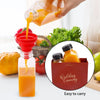 A hand pours orange juice from a glass into a reusable plastic juice bottle, with fresh ingredients nearby.