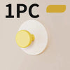 A single yellow suction cup hook is shown on a white circular background.