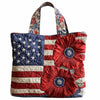 A vintage quilted tote bag featuring an American flag design with red, white, and blue stripes and stars.
