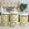 Three white porcelain storage jars with a gold rim and checkerboard pattern for tea, coffee, or sugar.