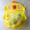 A yellow cartoon duck bath toy storage mesh bag with suction cups filled with various bath toys.