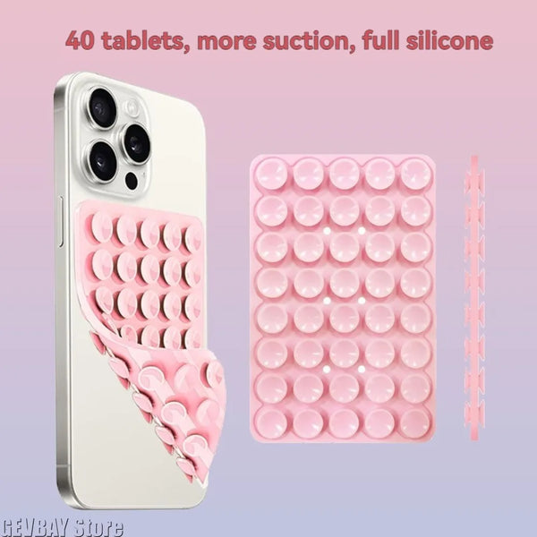 Pinkes Silikon-Saugnapf-Handyhalter mit 40 Tabletten neben einem Smartphone.
