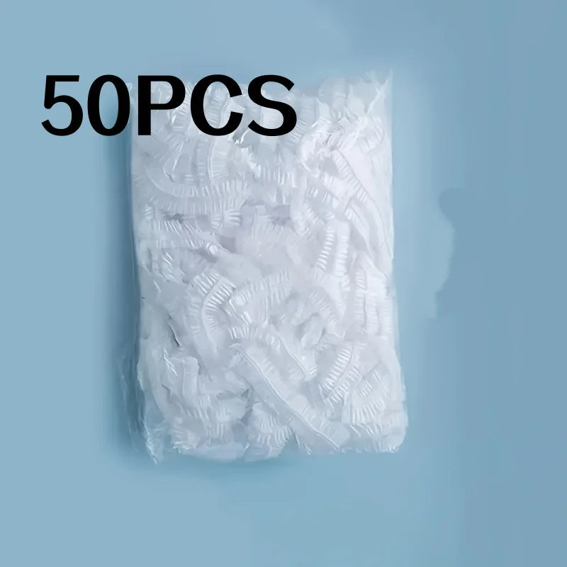 A pile of 50 transparent disposable shower caps for hair dyeing and bathing.