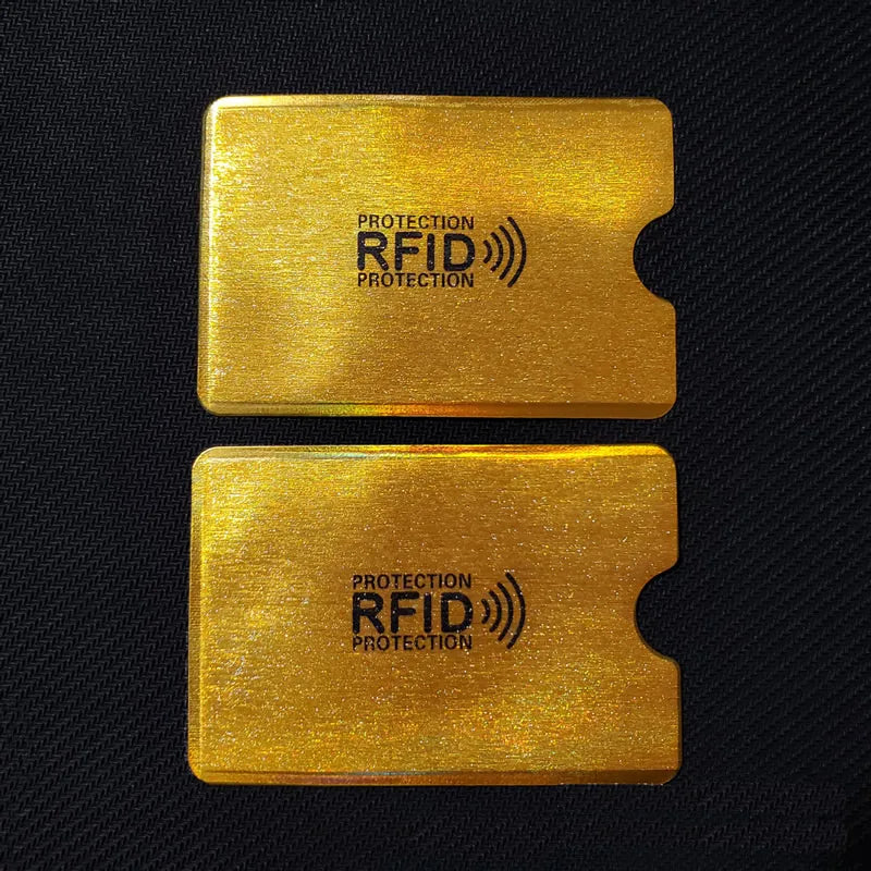 Two gold RFID protection cards are shown against a black background.