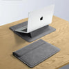 A silver laptop is placed inside a gray protective sleeve case on a wooden surface.
