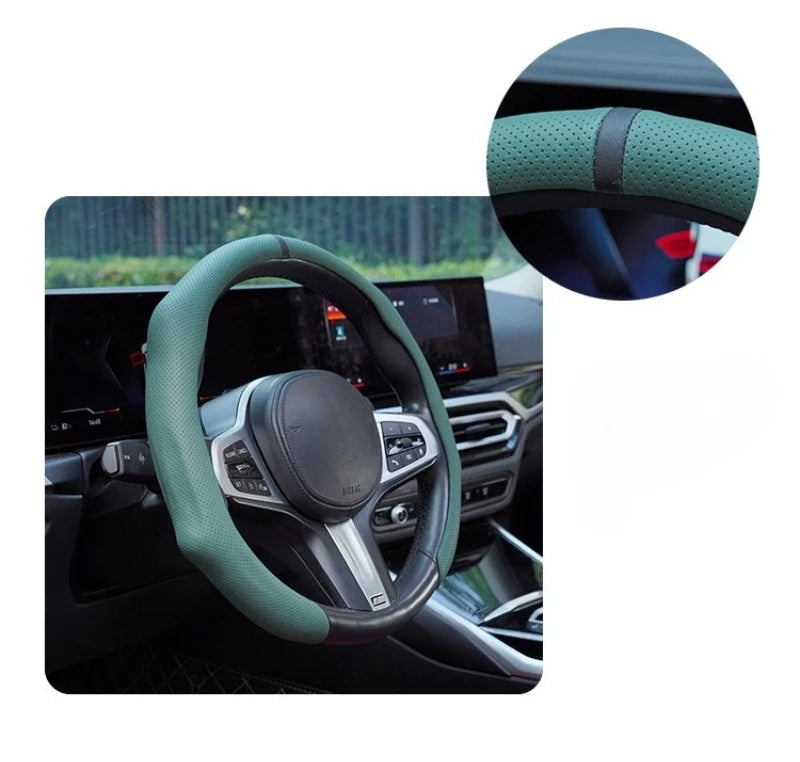 Close-up view of a green perforated leather steering wheel cover installed on a car's steering wheel.