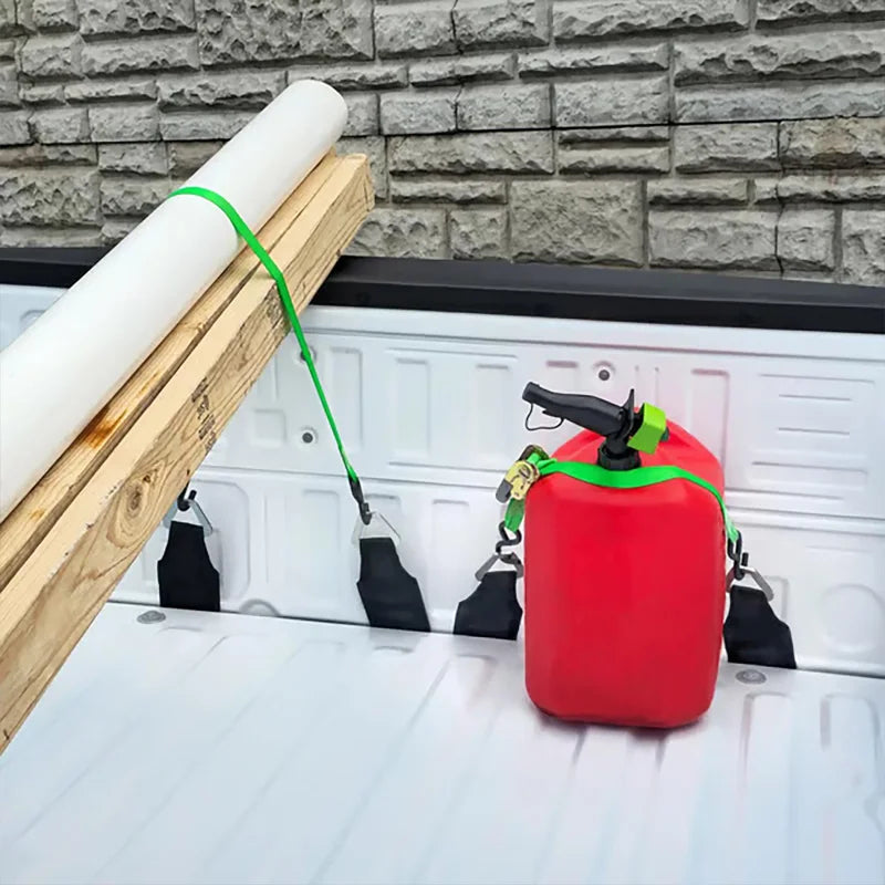 A red EZ Bed Anchor tie-down strap is shown hanging on a wooden plank against a gray brick wall.
