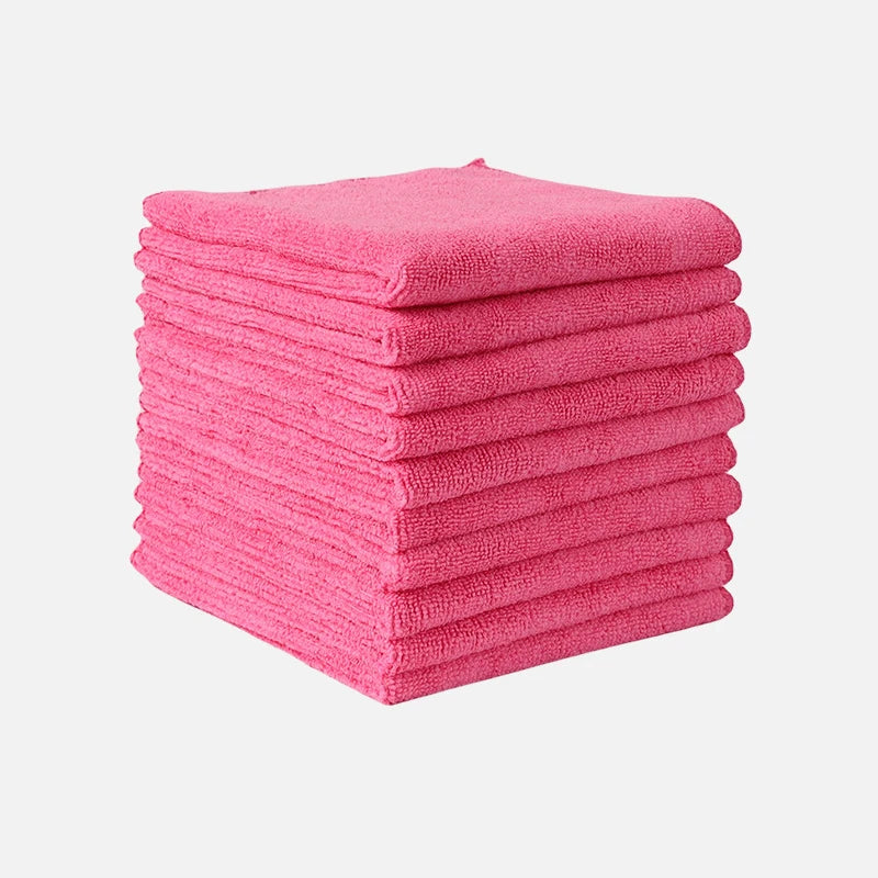 A stack of bright pink microfiber cleaning towels.