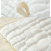 Close-up of soft natural cotton muslin baby washcloths showing their texture and folds.